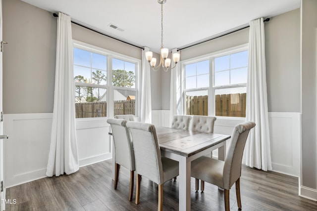 1209 Big Field Dr, Castle Hayne, NC 28429 - dining area featuring a chandelier, dark wood-type flooring, wainscoting, and visible vents