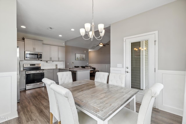 1209 Big Field Dr, Castle Hayne, NC 28429 - dining area with visible vents, dark wood finished floors, recessed lighting, ceiling fan with notable chandelier, and a wainscoted wall