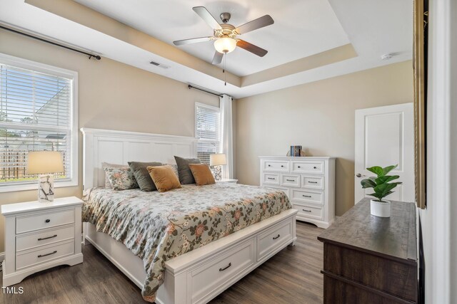 1209 Big Field Dr, Castle Hayne, NC 28429 - bedroom with visible vents, ceiling fan, a raised ceiling, and dark wood finished floors