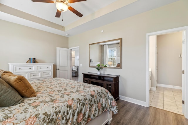 1209 Big Field Dr, Castle Hayne, NC 28429 - bedroom with a tray ceiling, dark wood-type flooring, baseboards, and a ceiling fan