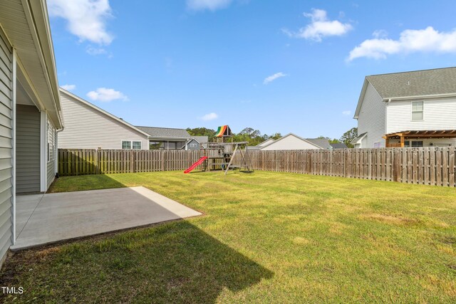 1209 Big Field Dr, Castle Hayne, NC 28429 - view of yard featuring a fenced backyard, a playground, and a patio
