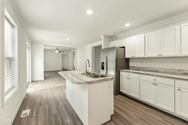 7120 Guess Rd, Hillsborough, NC 27278 - kitchen featuring white cabinetry, a sink, visible vents, ornamental molding, and stainless steel fridge