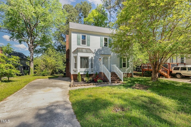 3109 E Folkestone Pl, Raleigh, NC 27604 - view of front of house featuring a wooden deck, a front lawn, and concrete driveway