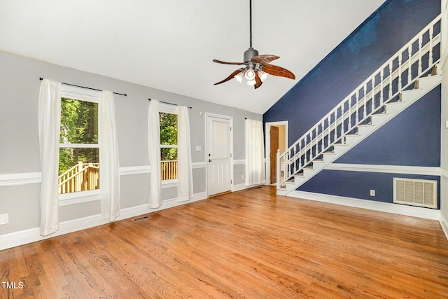 3109 E Folkestone Pl, Raleigh, NC 27604 - unfurnished living room with vaulted ceiling, stairway, visible vents, and a ceiling fan