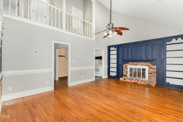 3109 E Folkestone Pl, Raleigh, NC 27604 - unfurnished living room with high vaulted ceiling, a ceiling fan, light wood-type flooring, a fireplace, and baseboards