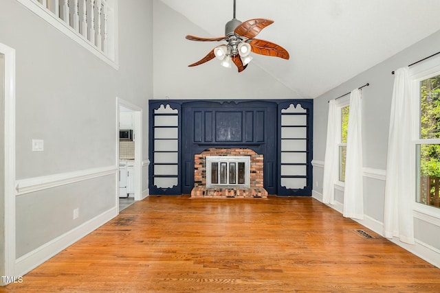 3109 E Folkestone Pl, Raleigh, NC 27604 - unfurnished living room featuring visible vents, a ceiling fan, a fireplace, light wood-style flooring, and high vaulted ceiling