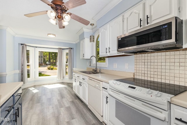 3109 E Folkestone Pl, Raleigh, NC 27604 - kitchen featuring white appliances, a sink, white cabinetry, and ornamental molding
