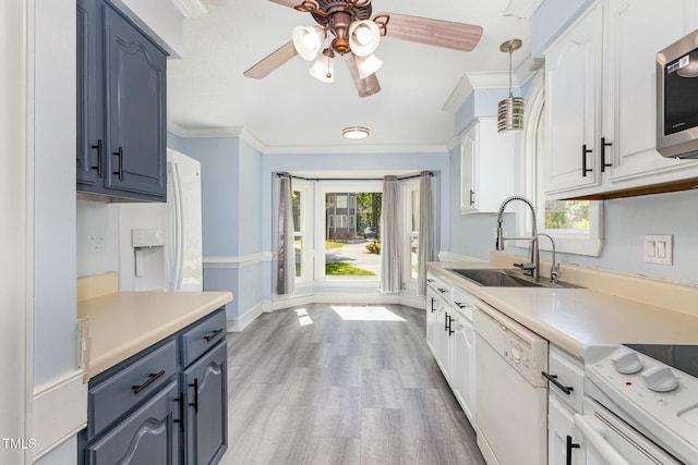 3109 E Folkestone Pl, Raleigh, NC 27604 - kitchen featuring light countertops, a ceiling fan, white appliances, crown molding, and blue cabinetry
