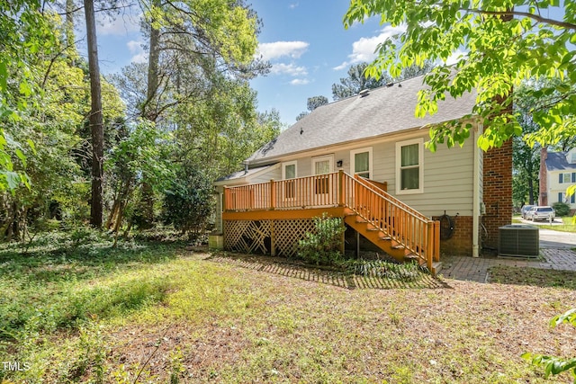 3109 E Folkestone Pl, Raleigh, NC 27604 - rear view of house featuring stairway, central AC unit, a shingled roof, a wooden deck, and brick siding