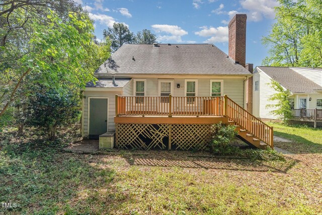 3109 E Folkestone Pl, Raleigh, NC 27604 - rear view of property with stairway, a chimney, a shingled roof, a wooden deck, and a lawn