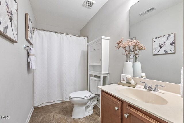4817 Quarryman Rd, Raleigh, NC 27610 - bathroom featuring toilet, vanity, a shower with shower curtain, and visible vents