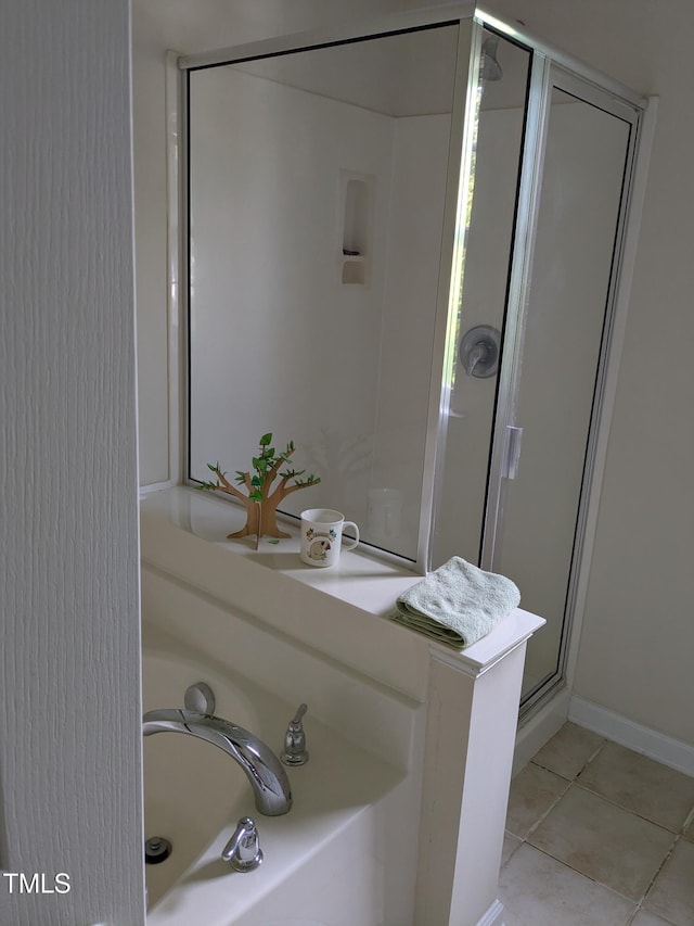 full bath with tile patterned floors, a stall shower, and a garden tub