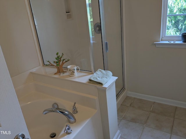 full bathroom with tile patterned flooring, a stall shower, baseboards, and a bath