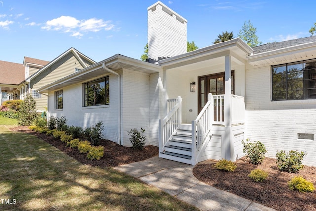 1310 Mayfair Rd, Raleigh, NC 27608 - view of front facade with brick siding and a chimney