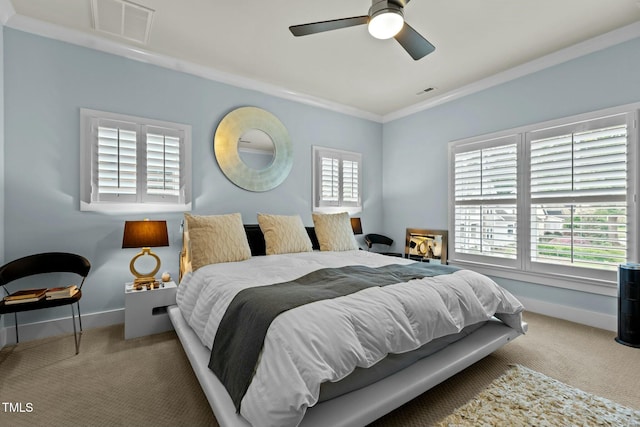carpeted bedroom with baseboards, ceiling fan, ornamental molding, and visible vents