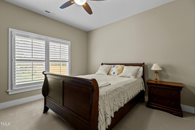 bedroom with baseboards, carpet flooring, visible vents, and a ceiling fan