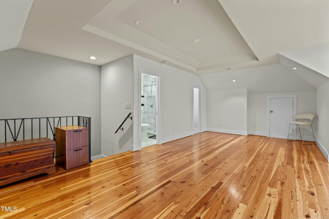 additional living space featuring lofted ceiling, light wood-style flooring, baseboards, and recessed lighting