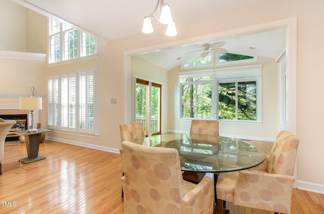 113 Beeley Ct, Cary, NC 27519 - dining room with a wealth of natural light, a glass covered fireplace, wood finished floors, and lofted ceiling