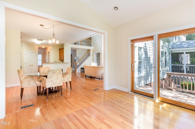 113 Beeley Ct, Cary, NC 27519 - dining room featuring baseboards, stairs, light wood-style floors, visible vents, and lofted ceiling