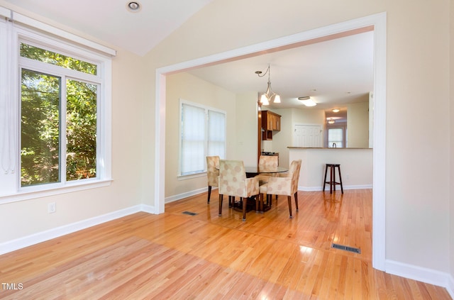 113 Beeley Ct, Cary, NC 27519 - dining space featuring a wealth of natural light, a notable chandelier, light wood-style flooring, and lofted ceiling