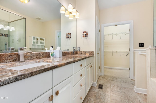 113 Beeley Ct, Cary, NC 27519 - full bath featuring a sink, visible vents, a shower stall, and an inviting chandelier