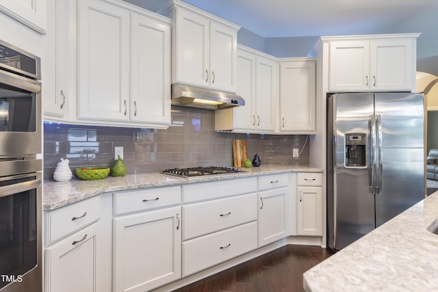 1005 Vesper Ct, Durham, NC 27703 - kitchen featuring appliances with stainless steel finishes, under cabinet range hood, white cabinetry, and tasteful backsplash