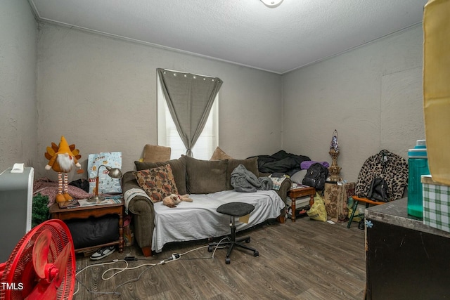 interior space featuring a textured ceiling, wood finished floors, and a textured wall