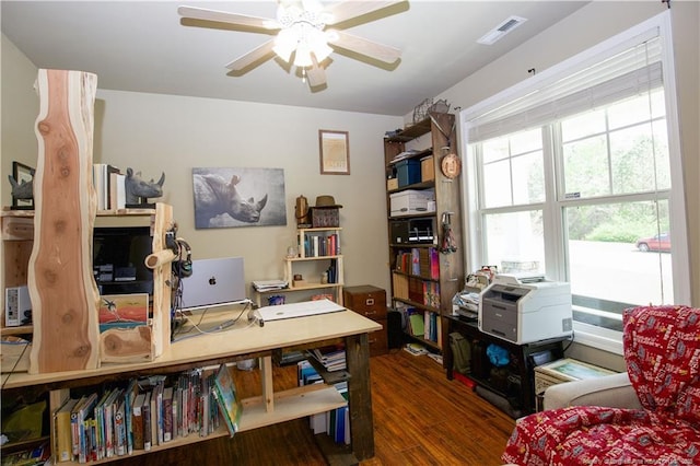 office space featuring wood finished floors, ceiling fan, and visible vents
