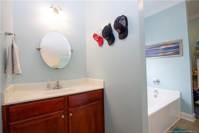 bathroom featuring tile patterned flooring, vanity, baseboards, and a bath