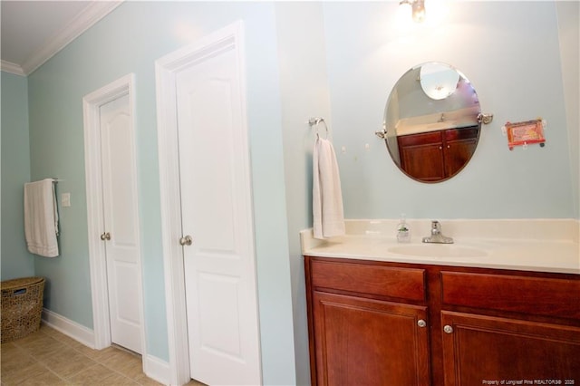 bathroom featuring crown molding, tile patterned flooring, baseboards, and vanity