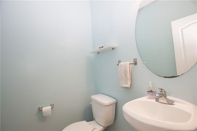 bathroom featuring toilet and a sink