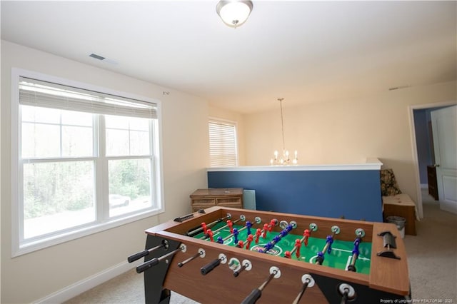 rec room with a notable chandelier, visible vents, baseboards, and carpet floors