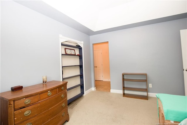 bedroom with baseboards and light carpet
