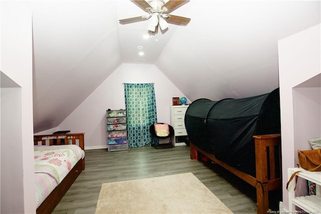 bedroom featuring visible vents, vaulted ceiling, a ceiling fan, and wood finished floors