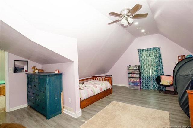 bedroom featuring baseboards, vaulted ceiling, and wood finished floors