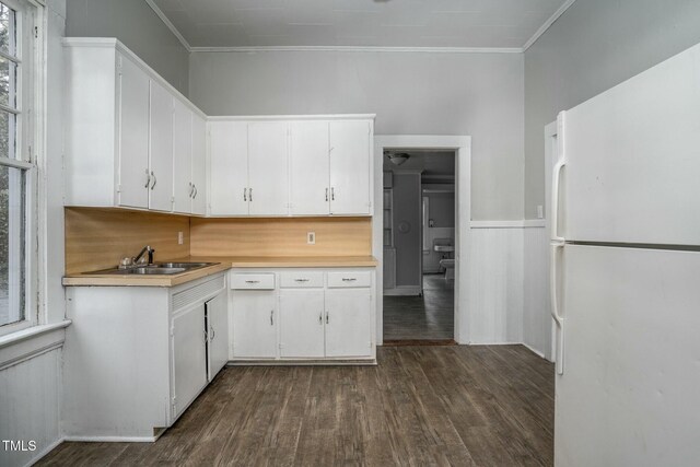 703 Cokey Rd, Rocky Mount, NC 27801 - kitchen featuring light countertops, freestanding refrigerator, white cabinets, dark wood-type flooring, and a sink