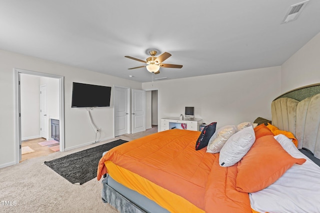 95 Shady Creek Trl, Garner, NC 27529 - carpeted bedroom with a ceiling fan, visible vents, ensuite bath, and baseboards