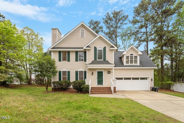 traditional-style house featuring a front lawn, an attached garage, a chimney, a shingled roof, and concrete driveway