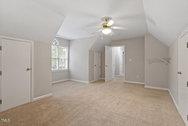 bonus room with baseboards, a ceiling fan, vaulted ceiling, and carpet floors