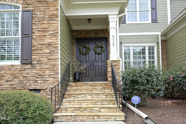 entrance to property featuring stone siding