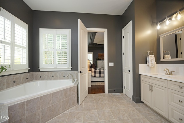 bathroom featuring vanity, tile patterned floors, ensuite bath, and a garden tub