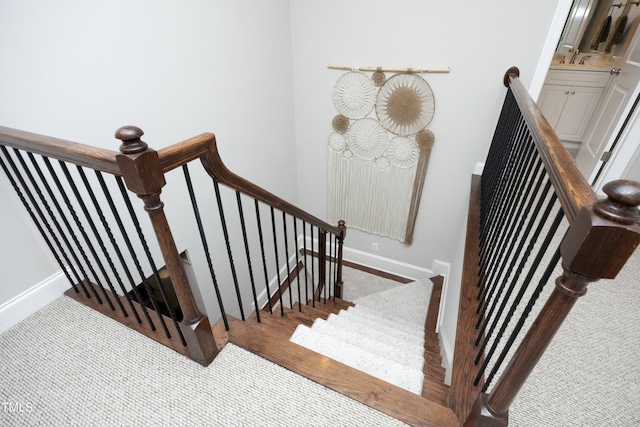 stairs with baseboards and wood finished floors