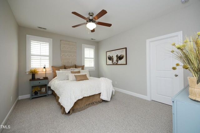 carpeted bedroom with baseboards and ceiling fan