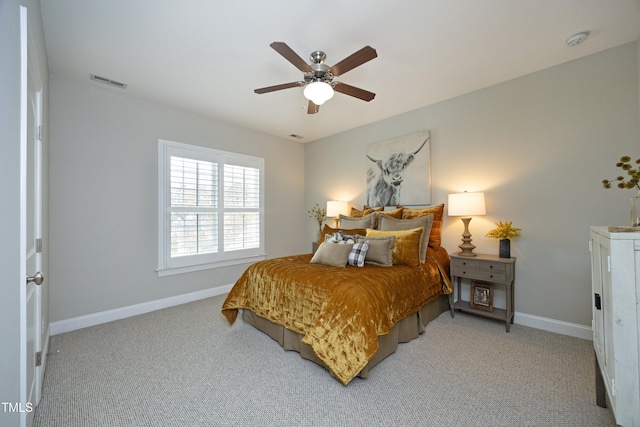 bedroom featuring light carpet, visible vents, and baseboards
