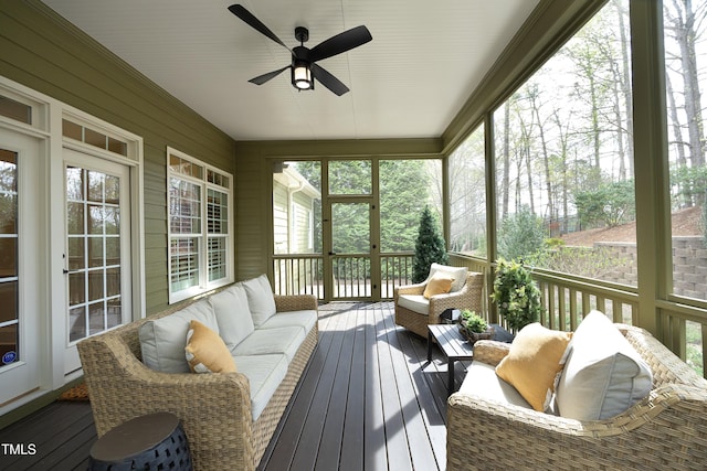 sunroom with an outdoor living space, a ceiling fan, and plenty of natural light