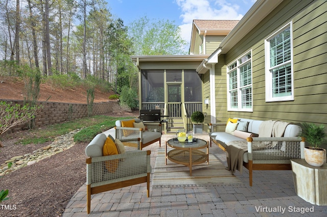 view of patio / terrace featuring a sunroom and an outdoor living space