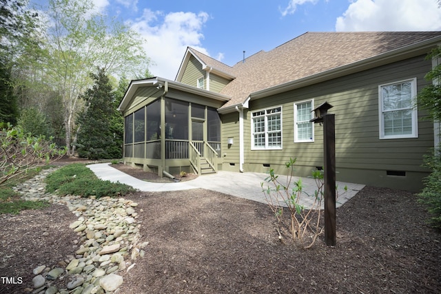 back of property featuring a patio, roof with shingles, crawl space, and a sunroom