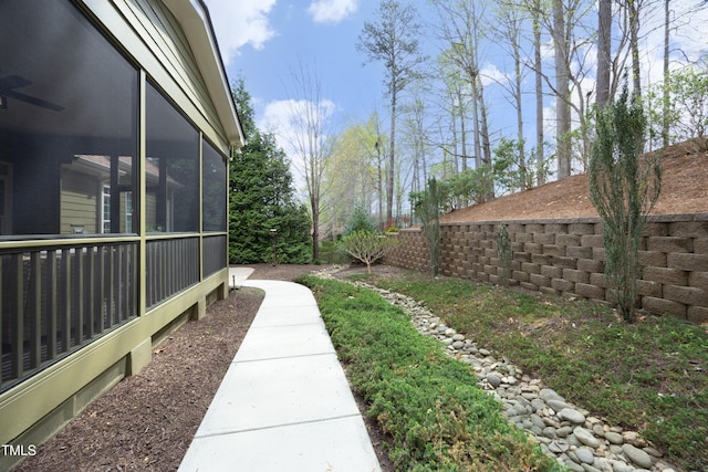 view of yard with fence and a sunroom