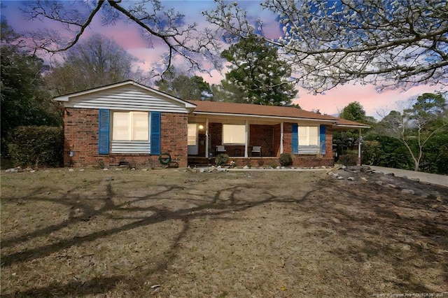 ranch-style house with brick siding and covered porch