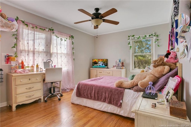 bedroom featuring light wood-type flooring, ceiling fan, and crown molding